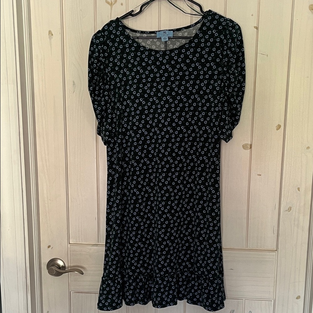 Floral green, black and blue midi dress with ruffle hem and short sleeves.